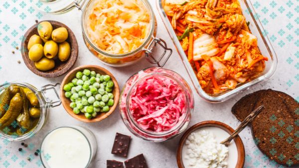 Prebiotic fiber and fermented foods are prebiotics that naturally feed probiotics in the gut